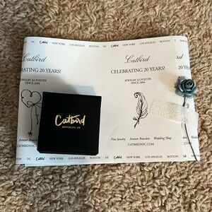 Catbird earring ring gift box with decorative paper and flower.